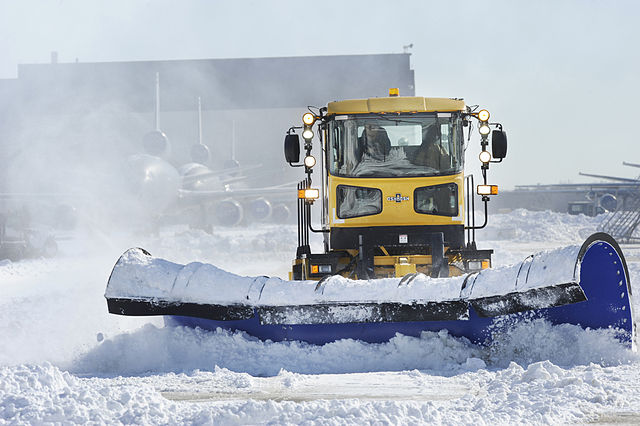 Snow plows trying to clear an airport's runways.