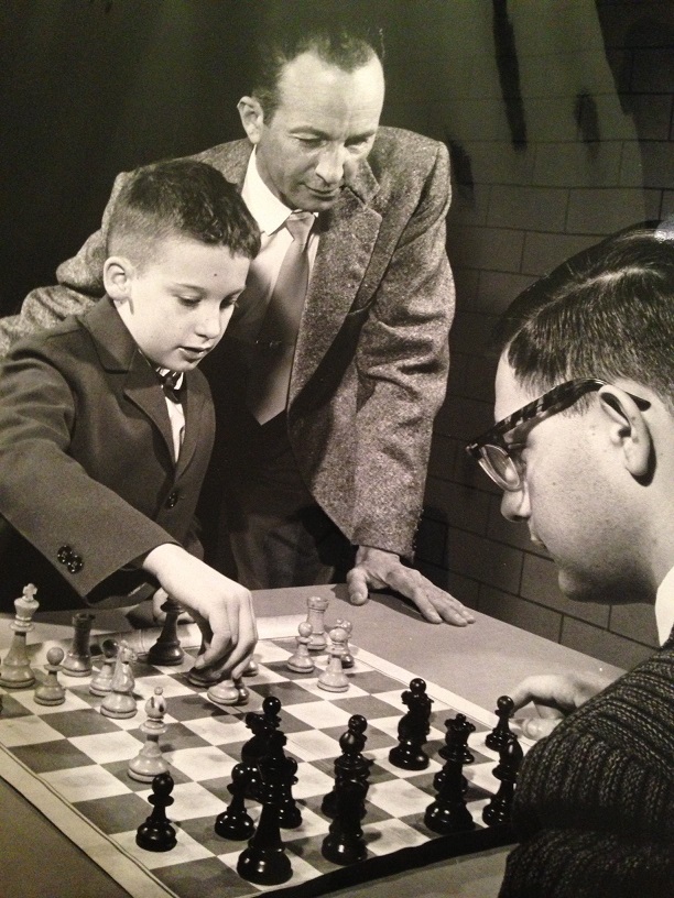 Dad watching my brother, Hank, play chess.