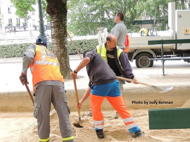 Men at work in park next to Cathedrale de Notre-Dame