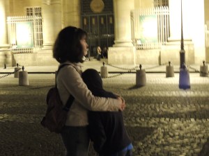 Mother and son enjoying a view of the Eiffel Tower at night